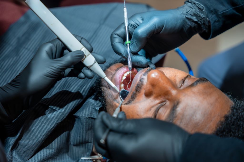 dentist performing teeth whitening procedure